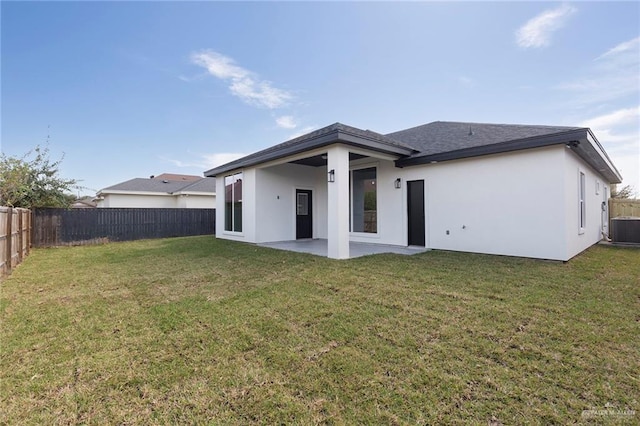 rear view of property with a lawn, central air condition unit, and a patio