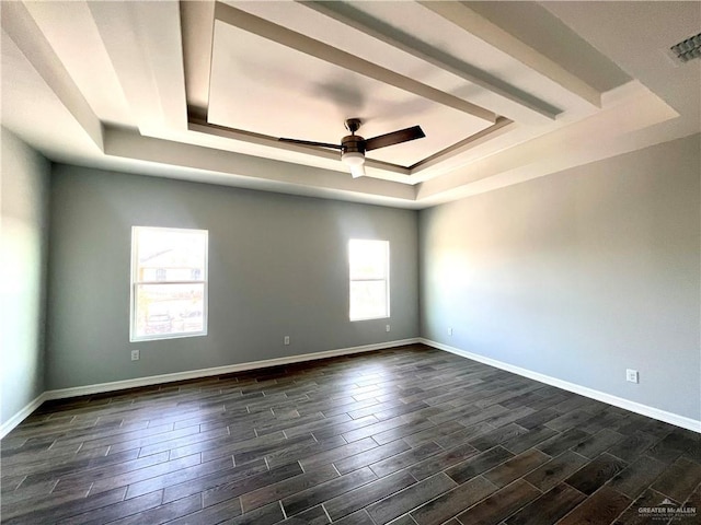 unfurnished room featuring ceiling fan and a tray ceiling