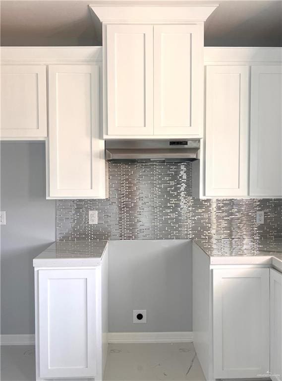 kitchen with white cabinets and decorative backsplash