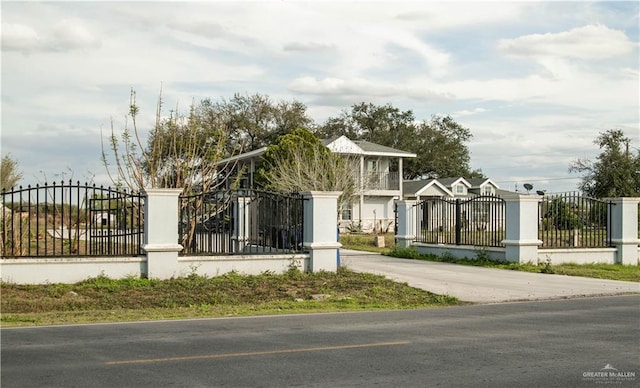 view of gate with a fenced front yard