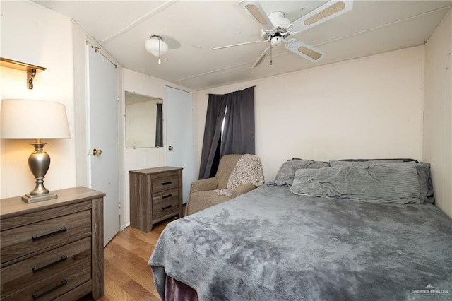 bedroom with ceiling fan and light hardwood / wood-style floors