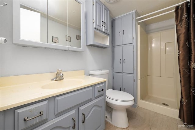 bathroom featuring a shower with curtain, tile patterned flooring, vanity, and toilet