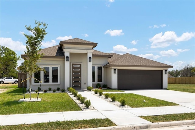 609 W La Pointe Ave, Alton, TX 78572 - prairie-style home featuring a garage, stucco siding, concrete driveway, and roof with shingles
