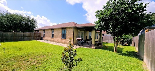 2409 Palmetto Dr Unit 48, Mission, TX 78574 - back of house featuring brick siding, a fenced backyard, and a patio