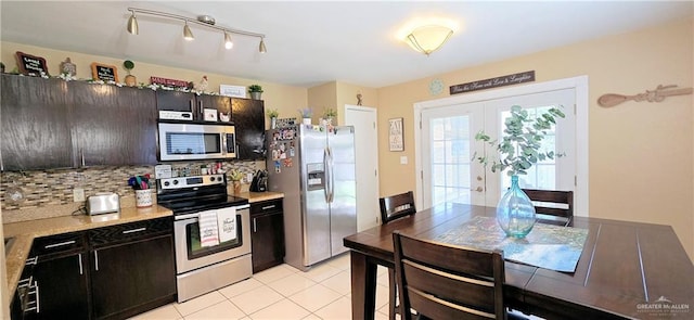 2409 Palmetto Dr Unit 48, Mission, TX 78574 - kitchen with stainless steel appliances, light countertops, backsplash, and light tile patterned floors