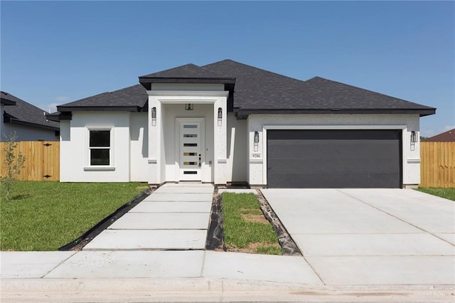 prairie-style house featuring a front yard and a garage