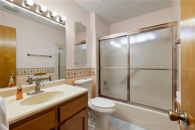 full bathroom featuring vanity, tile patterned floors, toilet, enclosed tub / shower combo, and a textured ceiling