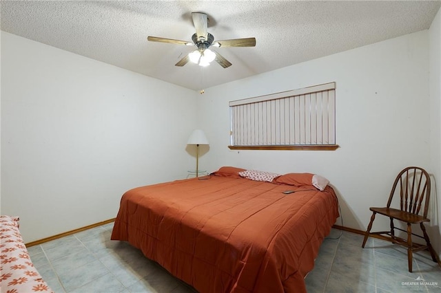 tiled bedroom featuring a textured ceiling and ceiling fan