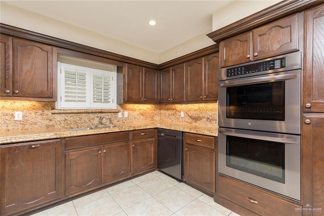 kitchen featuring double oven, dishwashing machine, a sink, light tile patterned floors, and decorative backsplash