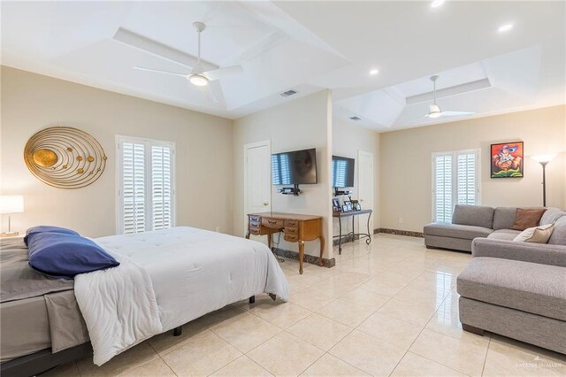 bedroom featuring a tray ceiling, light tile patterned floors, recessed lighting, a ceiling fan, and baseboards