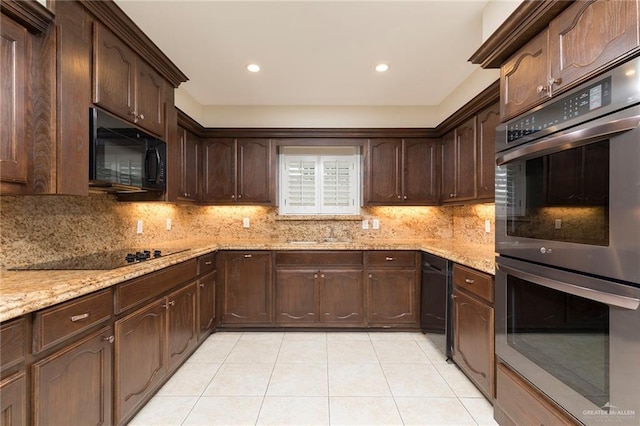 kitchen featuring black appliances, light tile patterned floors, decorative backsplash, dark brown cabinets, and light stone counters