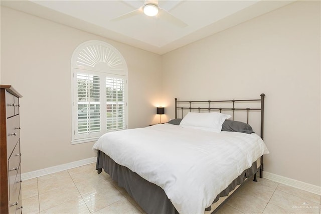 bedroom featuring light tile patterned flooring, baseboards, and ceiling fan