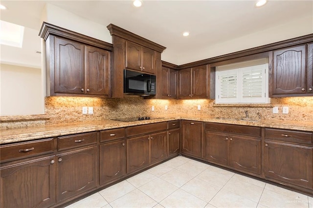 kitchen with black appliances, a sink, light tile patterned floors, dark brown cabinetry, and recessed lighting