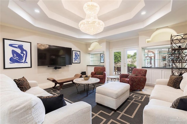 living area featuring a tray ceiling, a chandelier, crown molding, recessed lighting, and baseboards