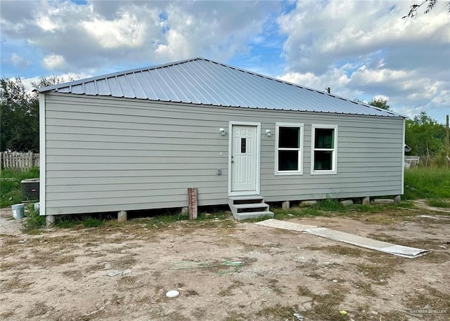 rear view of house with cooling unit