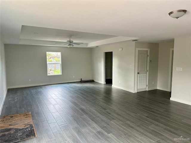 unfurnished room with a raised ceiling and ceiling fan