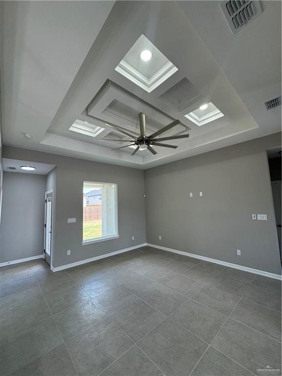12711 N 37th Ln, Mcallen, TX 78504 - spare room featuring coffered ceiling, a raised ceiling, dark tile patterned flooring, and a ceiling fan