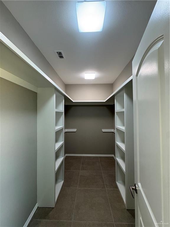 12711 N 37th Ln, Mcallen, TX 78504 - spacious closet featuring dark tile patterned floors