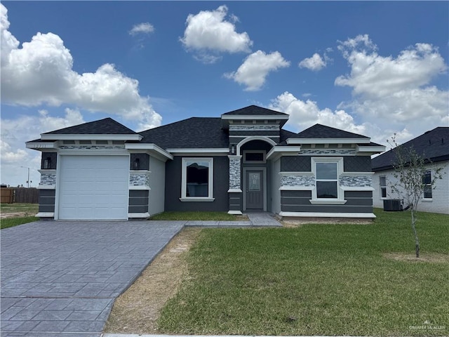 12711 N 37th Ln, Mcallen, TX 78504 - prairie-style home with decorative driveway, an attached garage, a front lawn, stone siding, and stucco siding