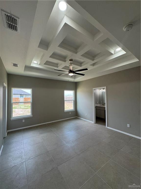 12711 N 37th Ln, Mcallen, TX 78504 - spare room with ceiling fan, a smoke detector, tile patterned floors, coffered ceiling, and beamed ceiling