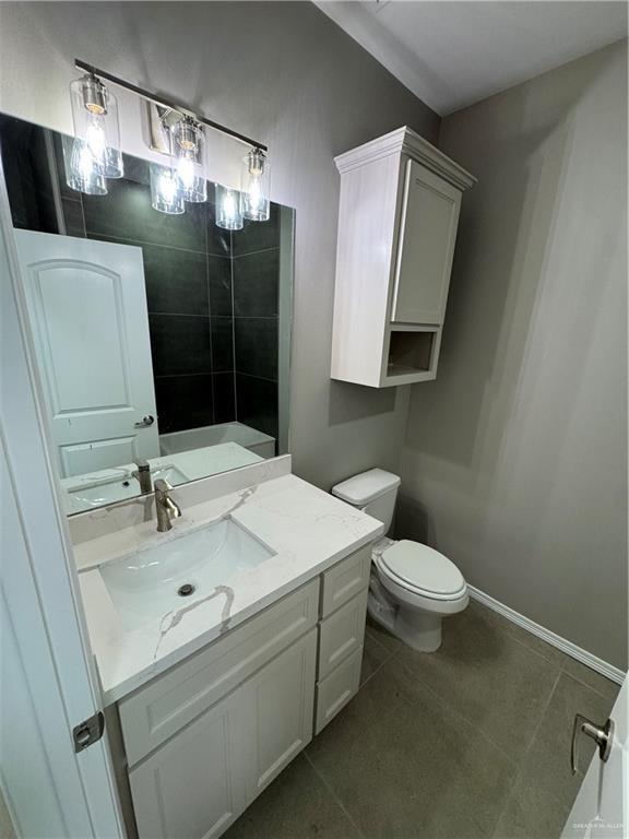 12711 N 37th Ln, Mcallen, TX 78504 - full bathroom featuring vanity, a shower, and tile patterned flooring