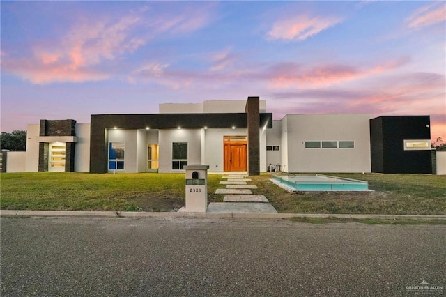 view of front of property with a lawn