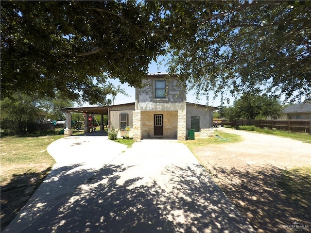4810 Amber St, Mission, TX 78574 - contemporary home featuring driveway, stone siding, fence, a carport, and stucco siding