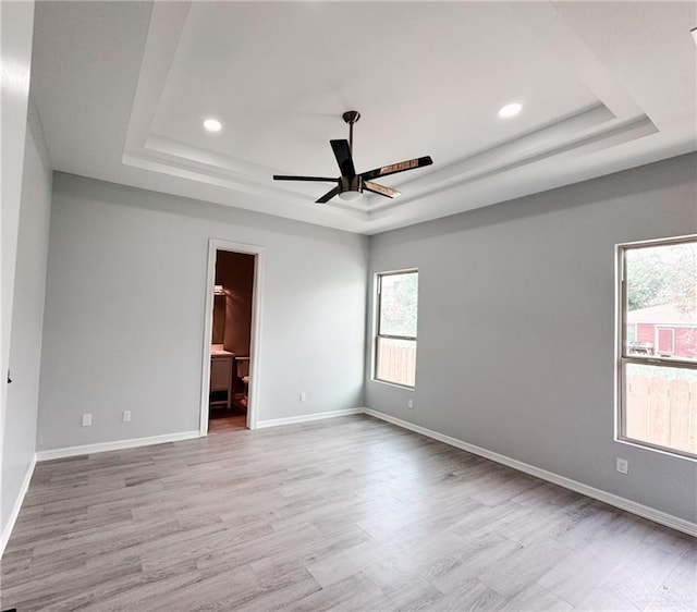 607 N 9th St, Alamo, TX 78516 - empty room with a raised ceiling, plenty of natural light, a ceiling fan, and recessed lighting