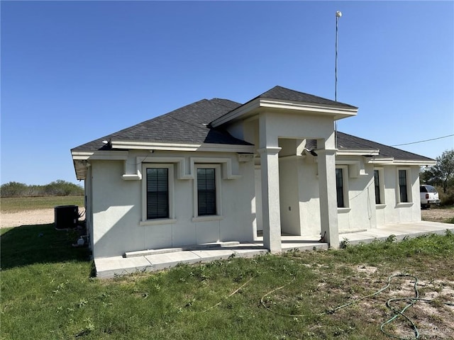 rear view of property featuring a yard