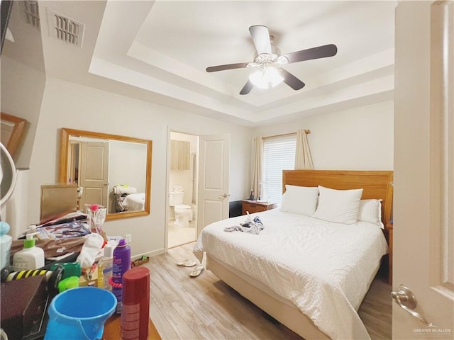1510 S Bilboa St Unit 1, Pharr, TX 78577 - bedroom with a raised ceiling, light wood-style floors, ensuite bath, baseboards, and a ceiling fan