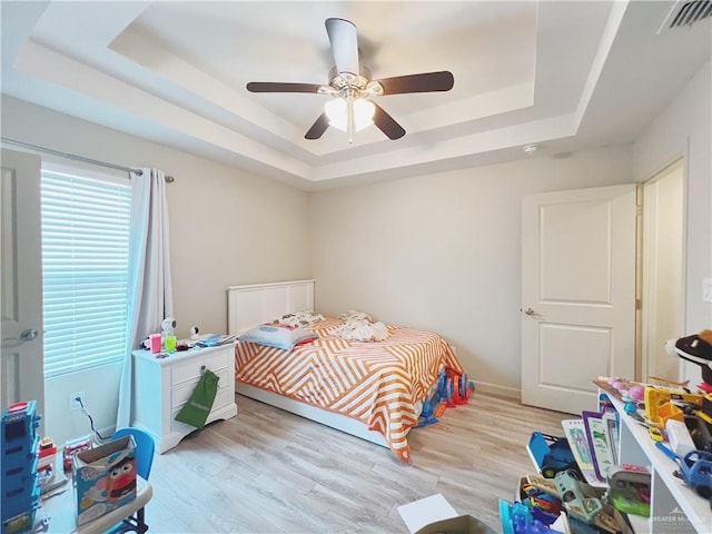 1510 S Bilboa St Unit 1, Pharr, TX 78577 - bedroom featuring a raised ceiling, light wood-type flooring, and ceiling fan