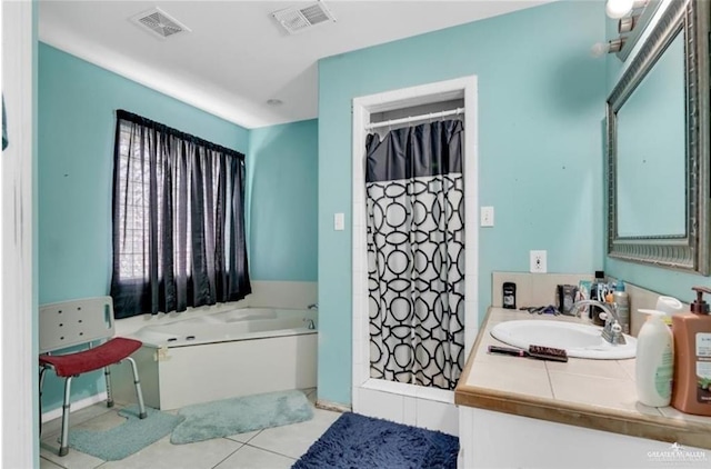 bathroom featuring vanity, a shower stall, visible vents, and tile patterned floors