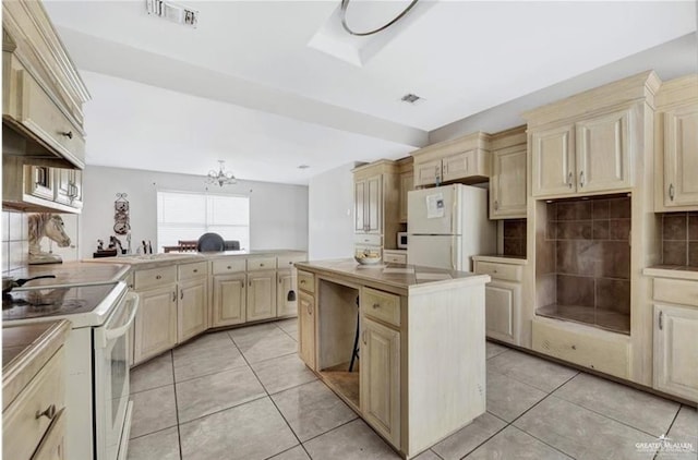 kitchen featuring a chandelier, visible vents, white appliances, and light tile patterned floors