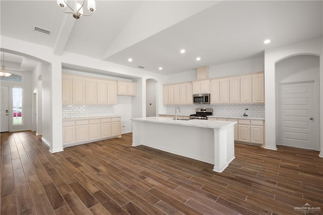 kitchen with decorative backsplash, dark hardwood / wood-style flooring, stainless steel appliances, and decorative light fixtures