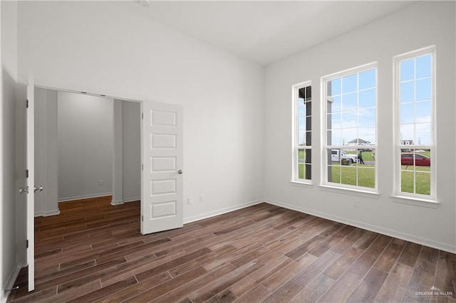 empty room featuring dark wood-type flooring