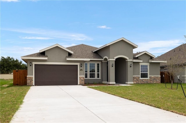 view of front facade featuring a front yard and a garage