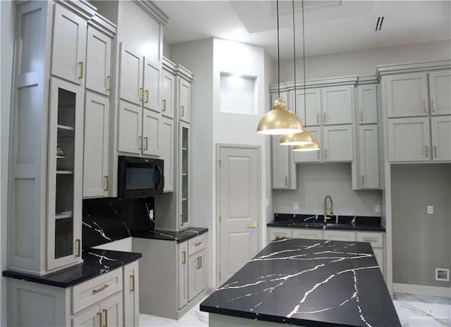 513 Quarry Dr, Mission, TX 78573 - kitchen featuring black microwave, light marble finish floors, a sink, pendant lighting, and a kitchen island