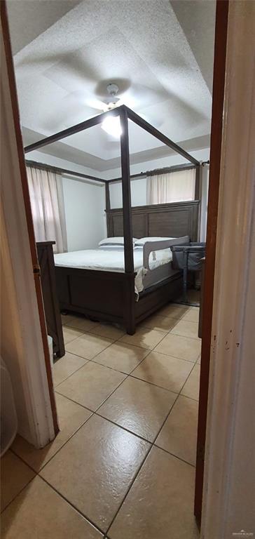 1319 Sago Palm St, Alamo, TX 78516 - bedroom with light tile patterned floors and ceiling fan