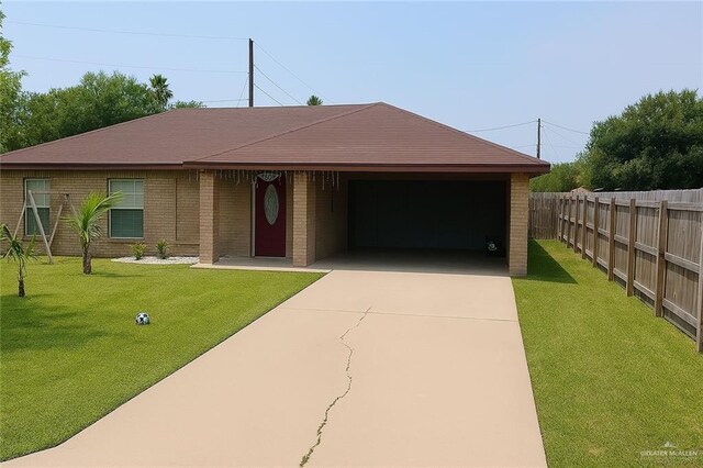 1319 Sago Palm St, Alamo, TX 78516 - view of front of home with driveway, an attached garage, and brick siding