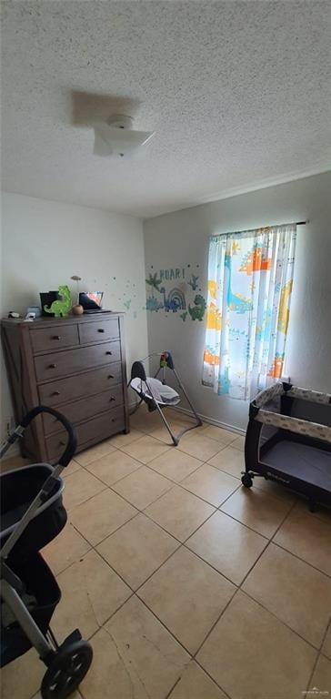1319 Sago Palm St, Alamo, TX 78516 - workout room featuring light tile patterned floors and a textured ceiling