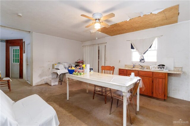 dining room featuring ceiling fan and sink