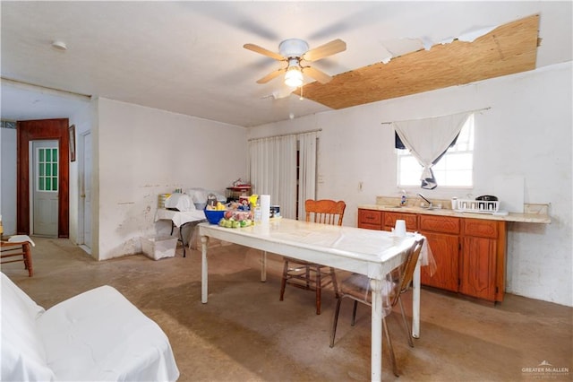 dining area featuring ceiling fan and sink