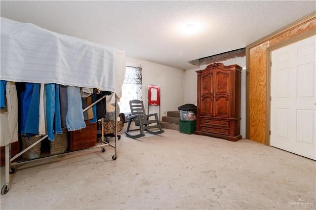 misc room with concrete flooring and a textured ceiling