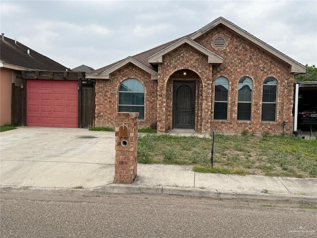 1008 Ivory Ave, Rio Grande City, TX 78582 - view of front facade with driveway, brick siding, and a garage