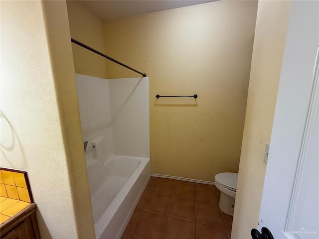 1008 Ivory Ave, Rio Grande City, TX 78582 - bathroom featuring tile patterned floors, toilet, baseboards, and shower / washtub combination