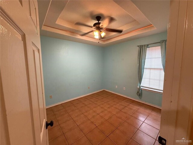 1008 Ivory Ave, Rio Grande City, TX 78582 - tiled empty room featuring a raised ceiling, a ceiling fan, and baseboards