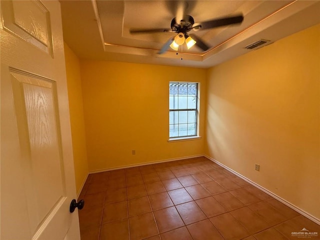 1008 Ivory Ave, Rio Grande City, TX 78582 - empty room with a raised ceiling, a ceiling fan, tile patterned floors, and baseboards