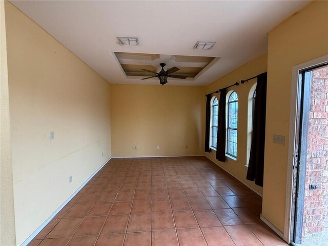 1008 Ivory Ave, Rio Grande City, TX 78582 - empty room with a tray ceiling, ceiling fan, and light tile patterned flooring