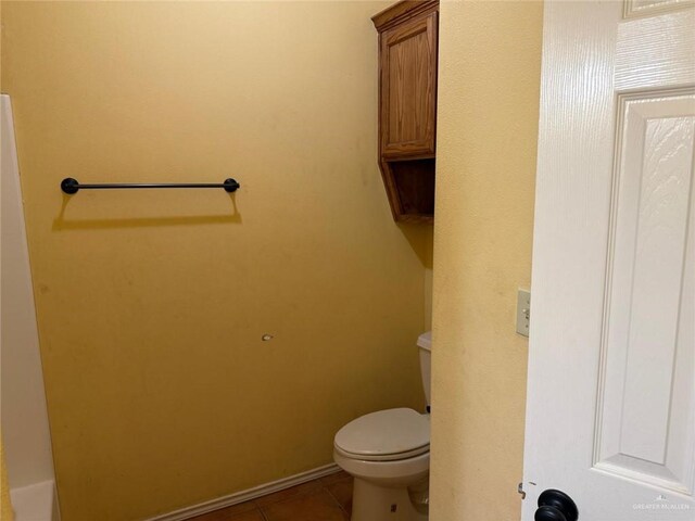 1008 Ivory Ave, Rio Grande City, TX 78582 - bathroom with toilet, tile patterned flooring, and baseboards