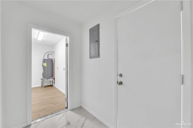 corridor featuring electric water heater, electric panel, and light hardwood / wood-style flooring